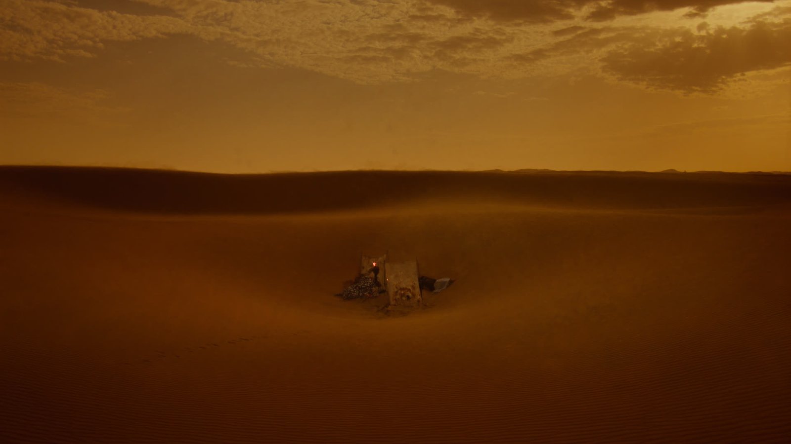 A small secluded wild camp deep among the Erg Chegaga dunes at sunset, no other camps in sight